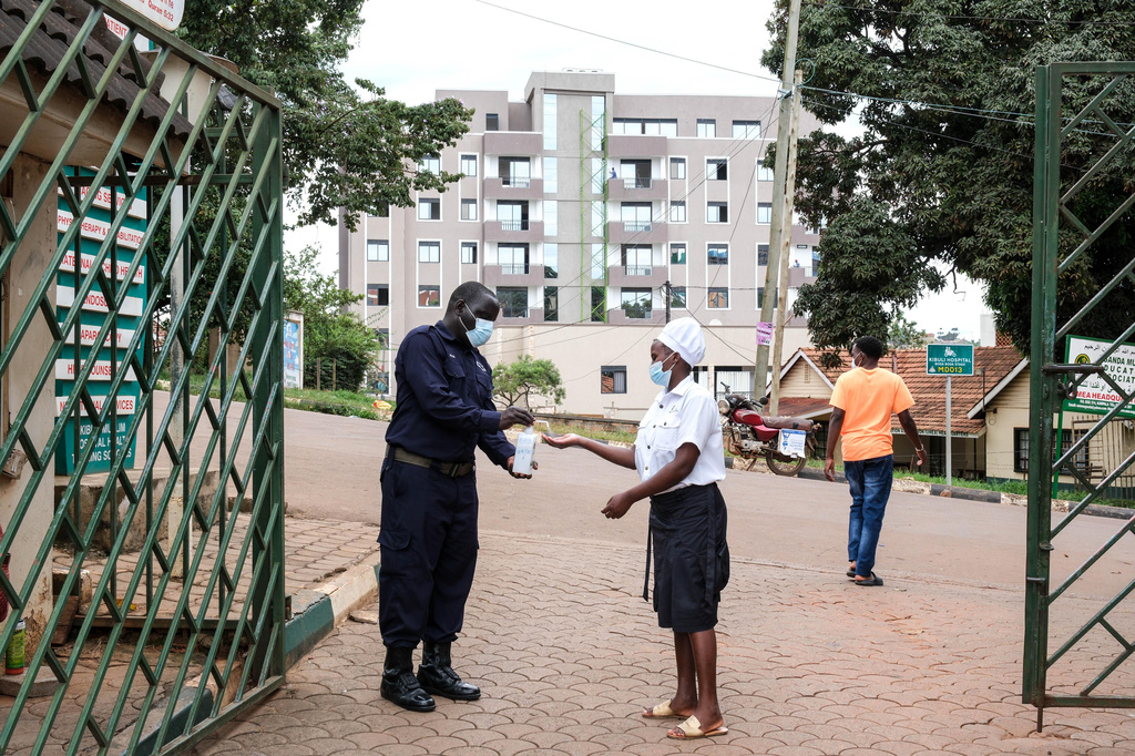 A woman sanitises her hands in front of Kibuli Muslim Hospital in Kampala, Uganda, Saturday, May 16, 2026. (AP Photo/ Hajarah Nalwadda)