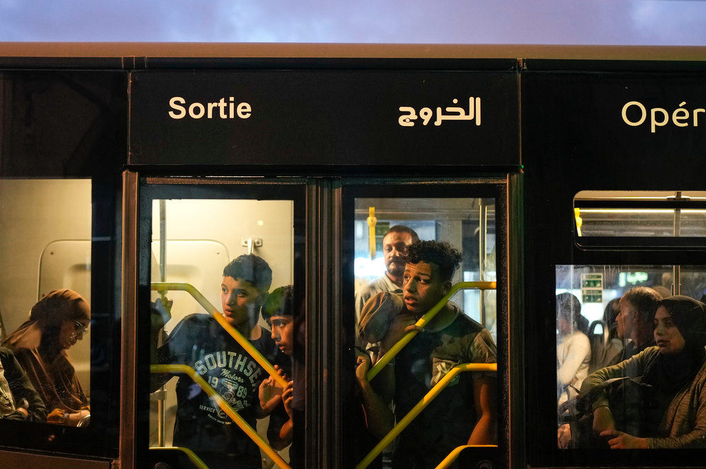 People observe as security forces detain a man taking part in a youth led protest calling for education and health reforms, in Casablanca, Morocco, Monday, Sept. 29, 2025. (AP Photo/Mosa'ab Elshamy)