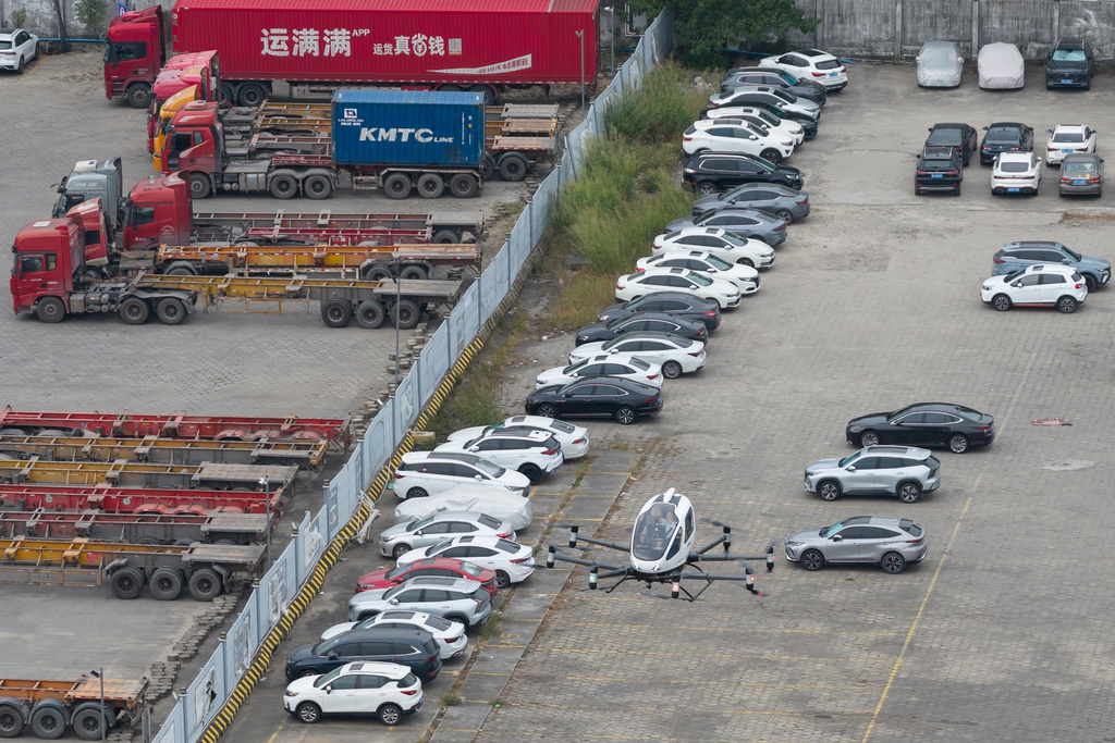 The EHang eVTOL EH126-S flies near over a car park in Guangzhou in southern China's Guangdong province on Monday, Nov. 3, 2025. (AP Photo/Ng Han Guan)