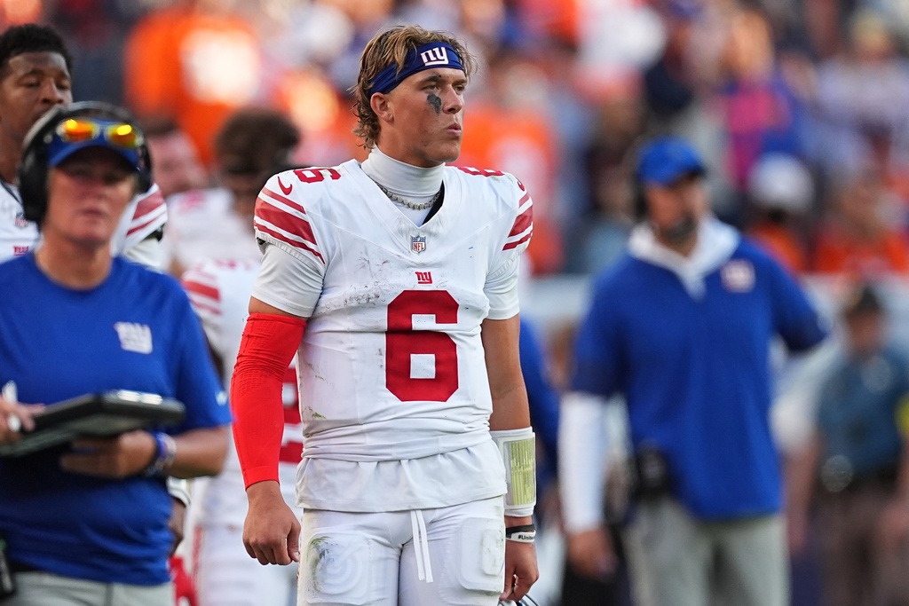 New York Giants quarterback Jaxson Dart (6) reacts from the sideline during the second half of an NFL football game against the Denver Broncos in Denver, Sunday, Oct. 19, 2025. (AP Photo/David Zalubowski)