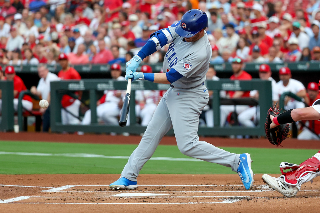 Chicago Cubs' Ian Happ hits a two-RBI double during the first inning of a baseball game against the St. Louis Cardinals Tuesday, July 28, 2026, in St. Louis. (AP Photo/Scott Kane)