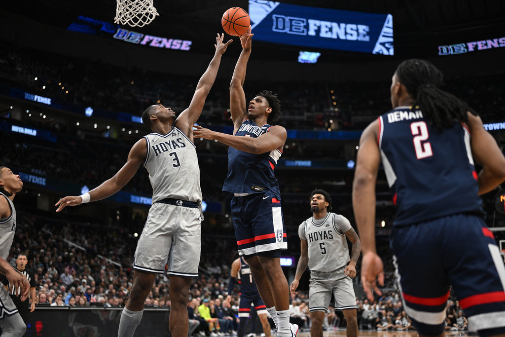 UConn forward Tarris Reed Jr. goes to shoot over Georgetown center Vincent Iwuchukwu (3) during the second half of an NCAA men's basketball game, Saturday, Jan. 17, 2026, in Washington. (AP Photo/John McDonnell)