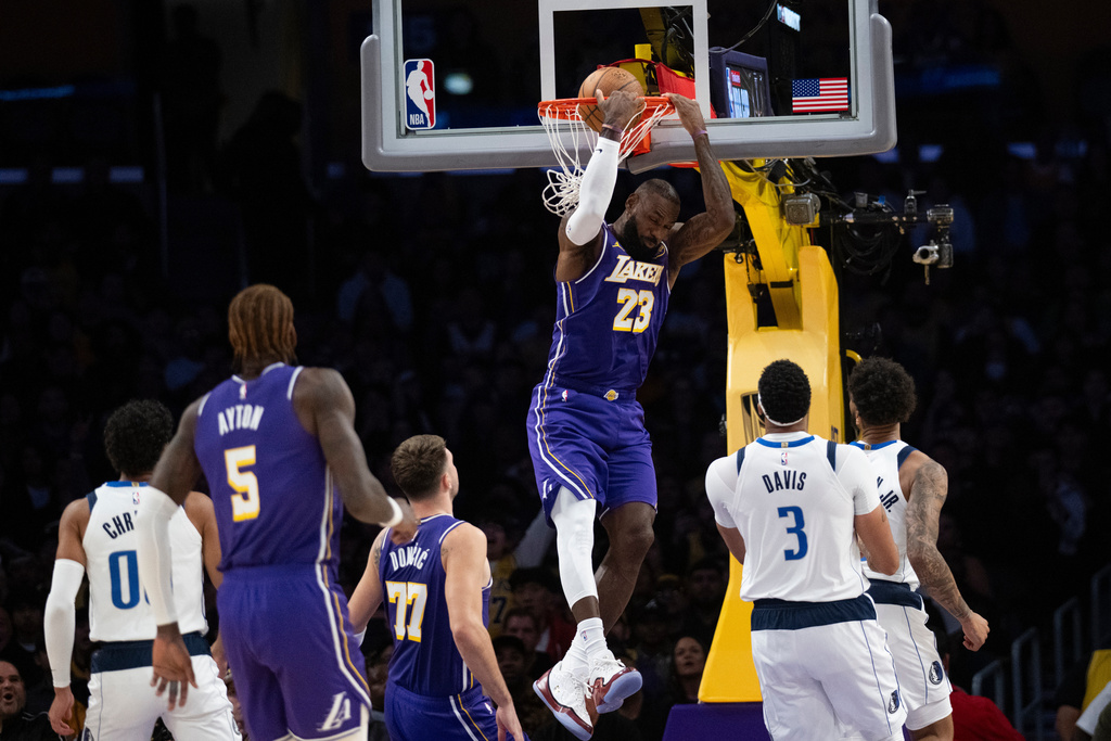 Los Angeles Lakers forward LeBron James (23) dunks during the first half of an NBA Cup basketball game against the Dallas Mavericks in Los Angeles, Friday, Nov. 28, 2025. (AP Photo/Kyusung Gong)