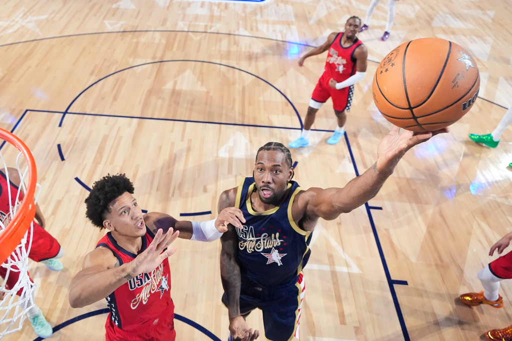 USA Stripes forward Kawhi Leonard (2) shoots past USA Stars guard Jalen Johnson in the NBA All-Star basketball game Sunday, Feb. 15, 2026, in Inglewood, Calif. (Ronald Martinez/Pool Photo via AP)