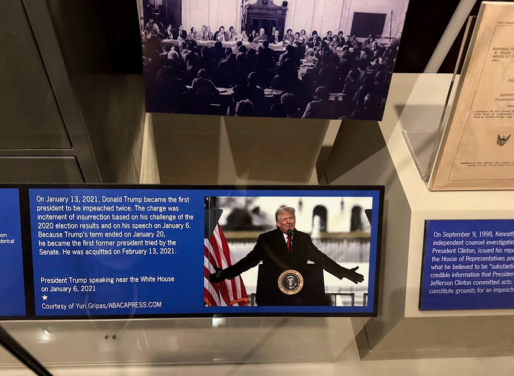 FILE - A new sign at the presidential impeachment exhibit in the Smithsonian's National Museum of American History in Washington, on Aug. 26, 2025, describes the counts against President Donald Trump in his second impeachment trial. The Senate acquitted him in both trials. (AP Photo/Calvin Woodward, File)