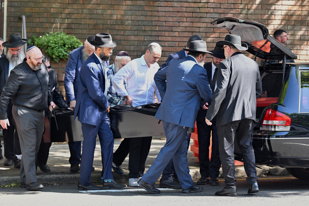 The casket is carried out during the funeral for Holocaust survivor and Bondi shooting victim, Alex Kleytman at Chevra Kadisha in Sydney, Thursday, Dec. 18, 2025. (Dean Lewins/AAP Image via AP)