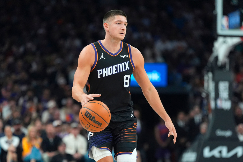 FILE - Phoenix Suns guard Grayson Allen dribbles the ball against the Oklahoma City Thunder during the first half of Game 4 in a first-round NBA playoffs basketball series, Monday, April 27, 2026, in Phoenix. (AP Photo/Ross D. Franklin, file)