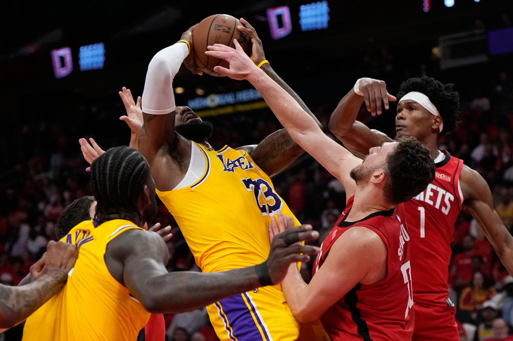 Houston Rockets center Alperen Sengun (28) fouls Los Angeles Lakers forward LeBron James (23) during the first half of Game 6 of a first-round NBA playoffs basketball series in Houston, Friday, May 1, 2026. (AP Photo/Ashley Landis)