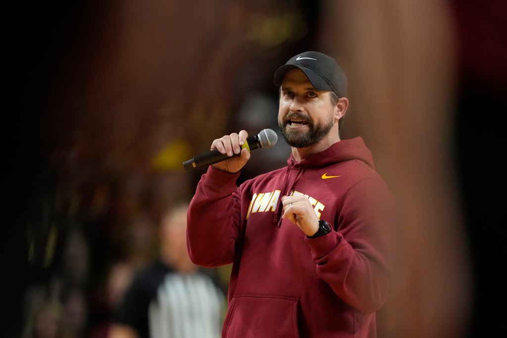 FILE - New Iowa State head football coach Jimmy Rogers speaks during a timeout in the first half of an NCAA college basketball game between Iowa State and Iowa, Dec. 11, 2025, in Ames, Iowa. (AP Photo/Charlie Neibergall, File)