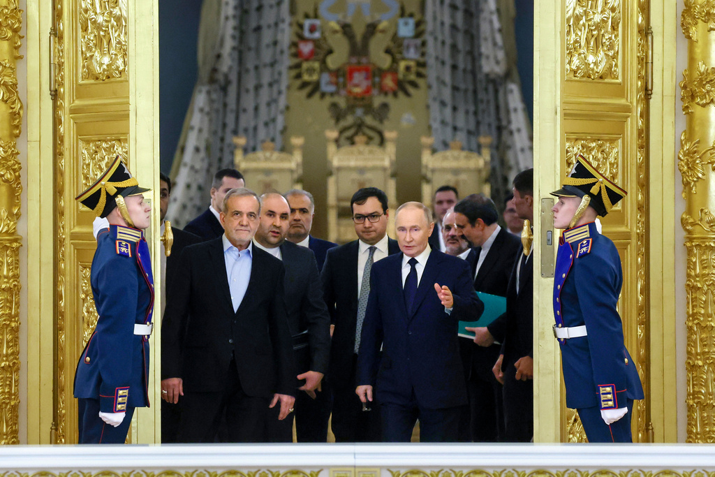 FILE - Iranian President Masoud Pezeshkian, center left, and Russian President Vladimir Putin, center right, arrive at a ceremony following their talks at the Kremlin in Moscow, Russia, on Jan. 17, 2025. (Vyacheslav Prokofyev, Sputnik, Kremlin Pool Photo via AP, File)