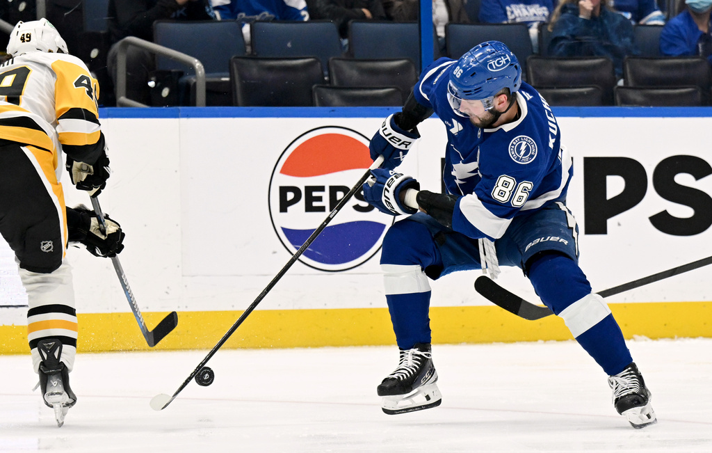 Pittsburgh Penguins defenseman Samuel Girard (49) and Tampa Bay Lightning right wing Nikita Kucherov (86) battle for the puck during the second period of an NHL hockey game, Thursday, April 2, 2026, in Tampa, Fla. (AP Photo/Jason Behnken)