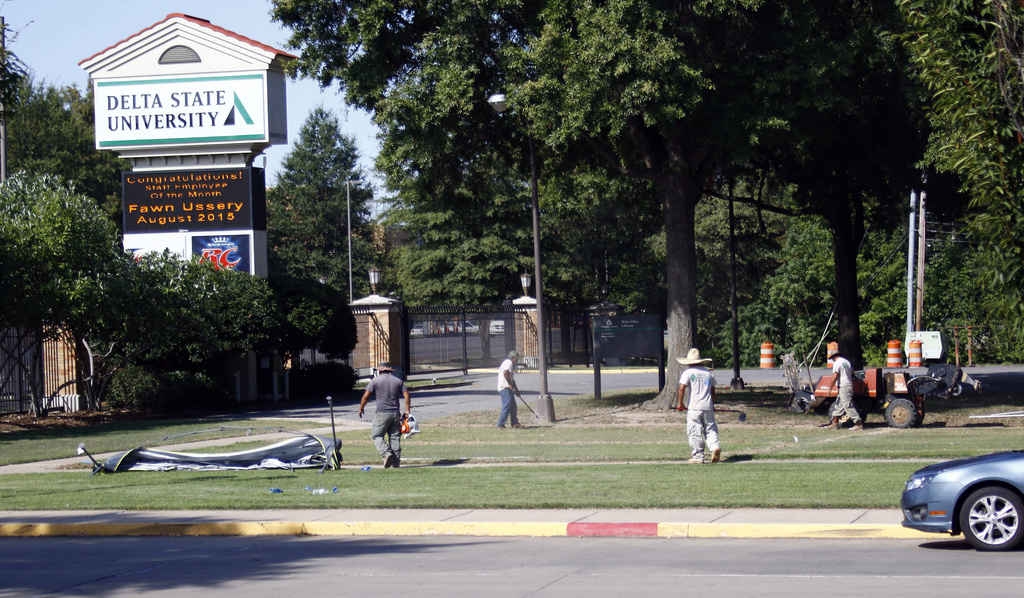 FILE - A grounds crew works on the lawn of Delta State University, in Cleveland, Miss., Sept. 15, 2015. (AP Photo/Rogelio V. Solis, FIle)