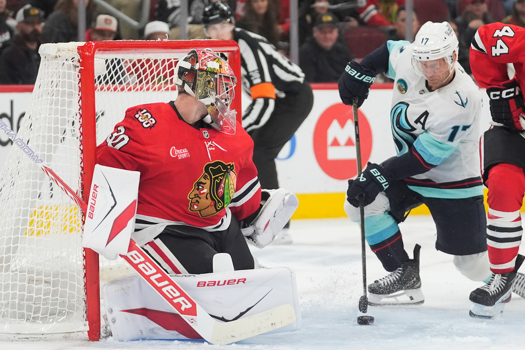 Seattle Kraken left wing Jaden Schwartz (17) scores against Chicago Blackhawks goaltender Spencer Knight, left, during the third period of an NHL hockey game Thursday, Nov. 20, 2025, in Chicago. (AP Photo/Erin Hooley)