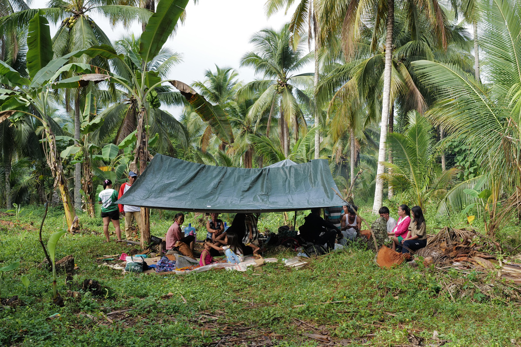 Residents stay under a tent at the earthquake-hit Manay town, Davao Oriental province, southern Philippines Saturday, Oct. 11, 2025. (AP Photo/Jeoffrey Maitem)