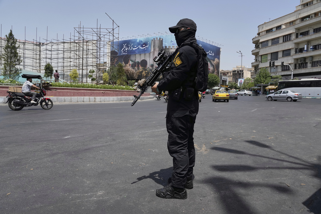 FILE—A member of Iran's Revolutionary Guard stands guard at Enqelab-e-Eslami (Islamic Revolution) square in downtown Tehran, Iran, June 24, 2025. (AP Photo/Vahid Salemi, File)