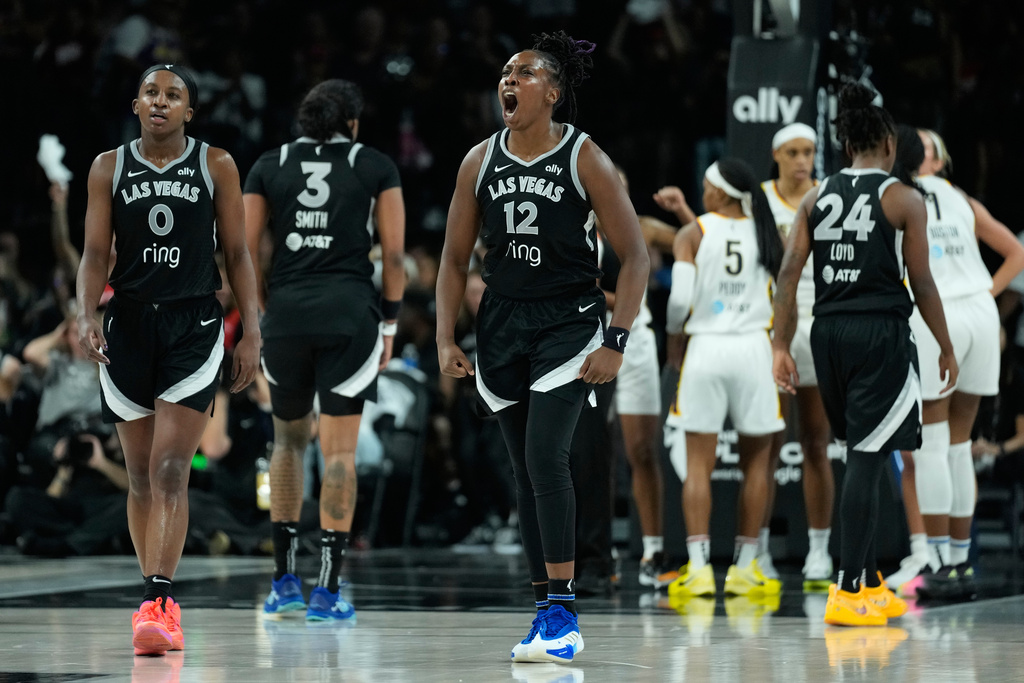 Las Vegas Aces guard Chelsea Gray (12) celebrates after a play against the Indiana Fever during the second half of Game 2 of a WNBA basketball playoff semifinals series Tuesday, Sept. 23, 2025, in Las Vegas. (AP Photo/John Locher)