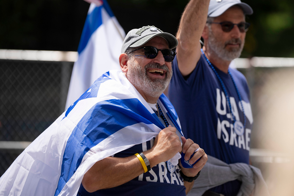 A parade participant smiles up at spectators during the Israel Day Parade, Sunday, May 31, 2026, in New York. (AP Photo/Emil T. Lippe)