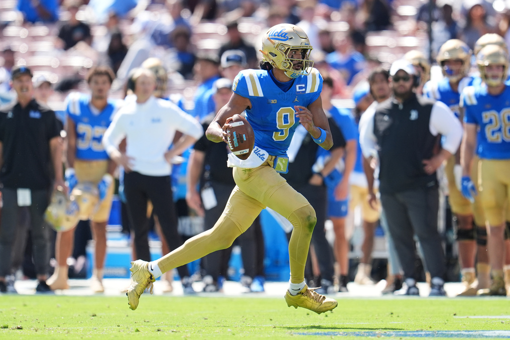 UCLA quarterback Nico Iamaleava (9) runs during the first half of an NCAA college football game against Penn State, Saturday, Oct. 4, 2025, in Pasadena, Calif. (AP Photo/Marcio Jose Sanchez)