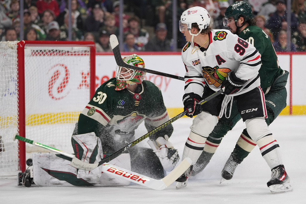 Chicago Blackhawks center Connor Bedard (98) scores a goal past Minnesota Wild goaltender Jesper Wallstedt (30) during the second period of an NHL hockey game, Thursday, March 19, 2026, in St. Paul, Minn. (AP Photo/Abbie Parr)
