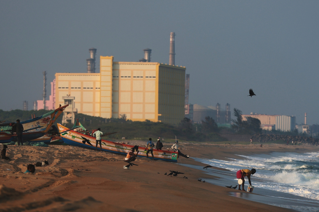 FILE - Fishermen tether a boat on the shore near the Madras Atomic Power Station, a nuclear power facility, at Kalpakkam, in the Indian state of Tamil Nadu, Feb. 10, 2025. (AP Photo/R. Parthibhan, File)