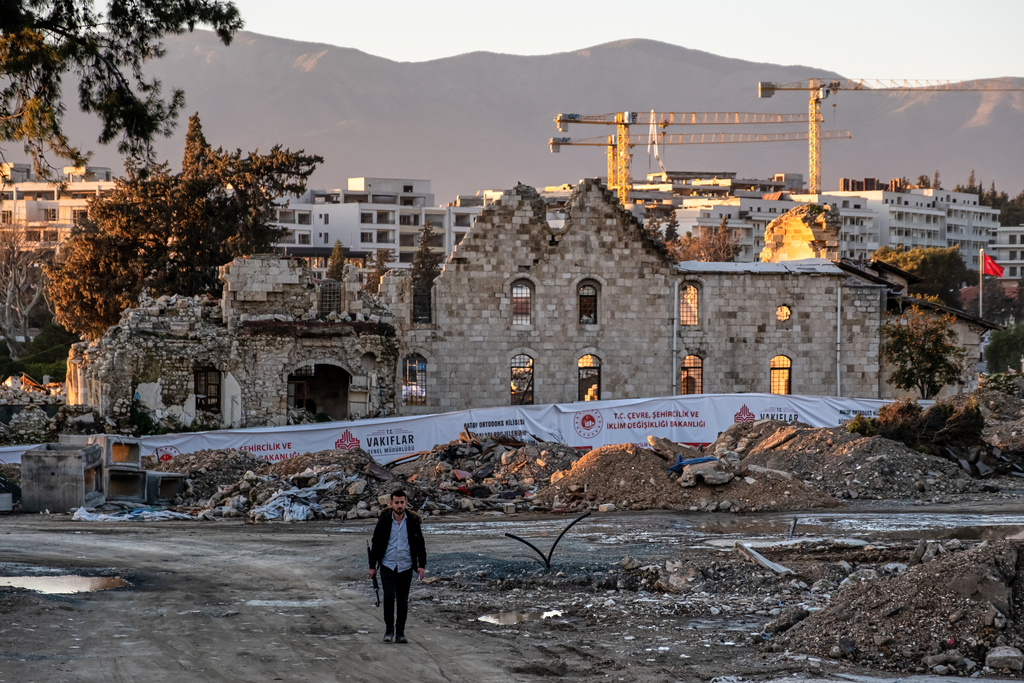 A man walks past the ruins of St. Paul Orthodox Church during debris removal efforts following the February 2023 earthquakes in Antakya, southern Turkey, Wednesday, Feb. 4, 2026. (AP Photo/Murat Kocabas)