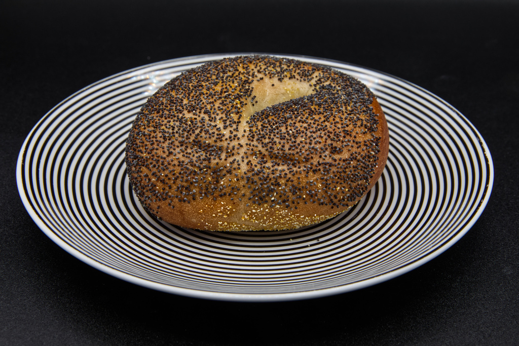 A poppy seed bagel on a plate photographed in Phoenix, Ariz., Monday, July 20, 2026. (AP Photo/Dario Lopez-Mills)