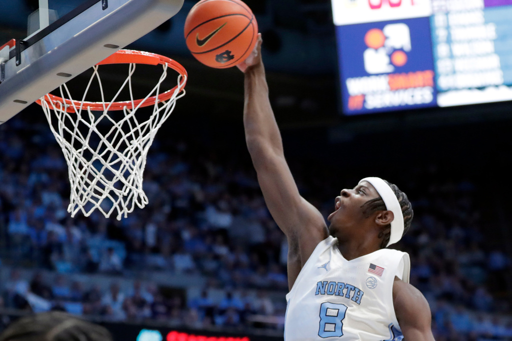North Carolina forward Caleb Wilson (8) goes in for a dunk during the first half of an NCAA college basketball game against East Carolina, Monday, Dec. 22, 2025, in Chapel Hill, N.C. (AP Photo/Chris Seward)