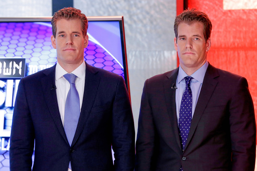 FILE - Cameron Winklevoss, left, and Tyler Winklevoss, founders of Gemini Trust Co., wait to appear on the "Countdown to the Closing Bell with Liz Claman" program, on the Fox Business Network, in New York, Oct. 8, 2015. (AP Photo/Richard Drew, File) FILE - Cameron Winklevoss, left, and Tyler Winklevoss, founders of Gemini Trust Co., wait to appear on the "Countdown to the Closing Bell with Liz Claman" program, on the Fox Business Network, in New York, Oct. 8, 2015. (AP Photo/Richard Drew, File)