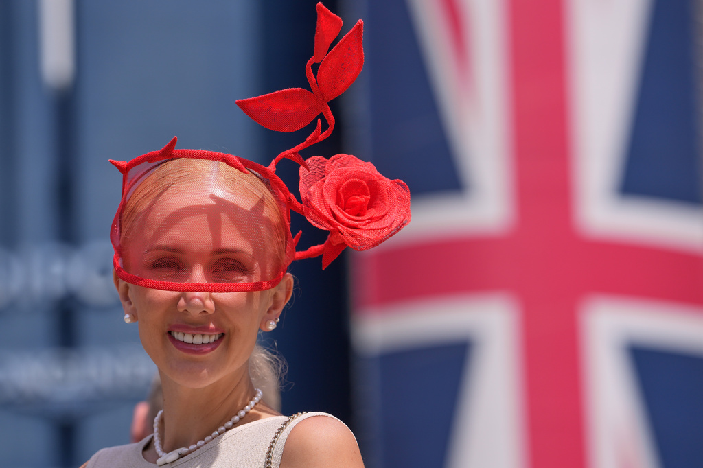A racegoer poses for photographers on the first day of the Royal Ascot horse race meeting in Ascot, England, Tuesday, June 16, 2026.(AP Photo/Kin Cheung)