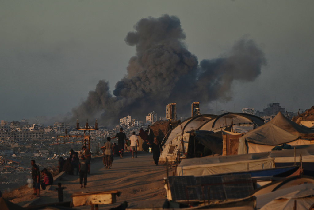 Smoke rises following an Israeli military strike in Gaza City, as seen from the central Gaza Strip, Wednesday, Oct, 1, 2025. (AP Photo/Abdel Kareem Hana)