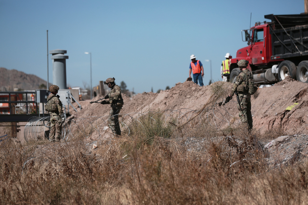 Security forces install barbed wire along the U.S. border in Ciudad Juarez, Mexico, Wednesday, Feb. 11, 2026, near El Paso, Texas. (AP Photo/Christian Chavez)