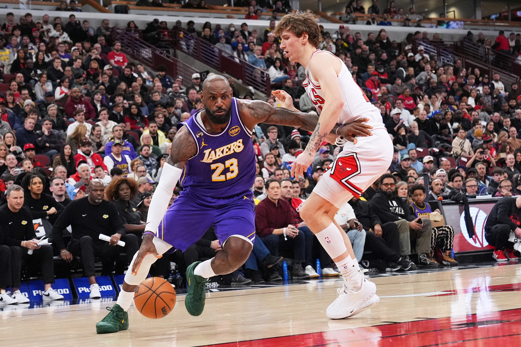 Los Angeles Lakers forward LeBron James, left, drives as Chicago Bulls forward Matas Buzelis guards during the first half of an NBA basketball game in Chicago, Monday, Jan. 26, 2026. (AP Photo/Nam Y. Huh)