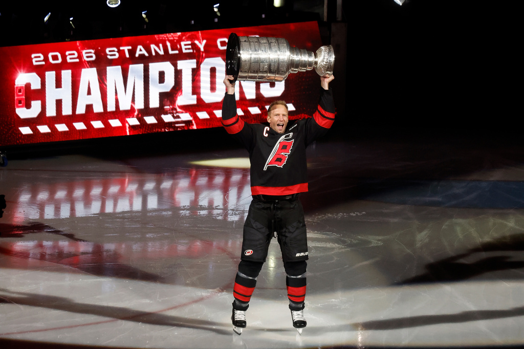Carolina Hurricanes' Jordan Staal (11) skates onto the ice hold the cup during the team's Stanley Cup celebration before their season-opening NHL hockey game against the Florida Panthers in Raleigh, N.C., Tuesday, Sept. 29, 2026. (AP Photo/Karl DeBlaker)