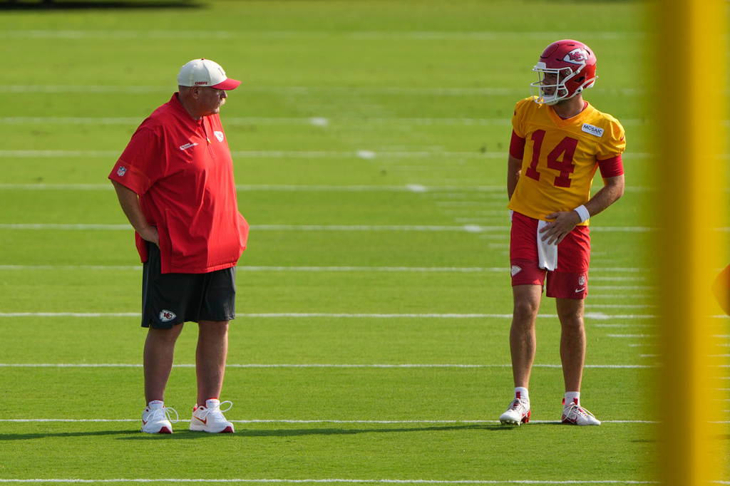 Kansas City Chiefs head coach Andy Reid talks to quarterback Garrett Nussmeier (14) during practice at NFL football training camp Saturday, July 25, 2026, in St. Joseph, Mo. (AP Photo/Charlie Riedel)