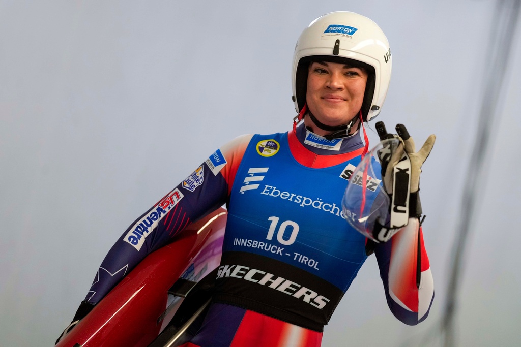 FILE - Summer Britcher of the United States waves after the women's sprint race at the Luge World Cup in Igls near Innsbruck, Austria, Dec. 7, 2024. (AP Photo/Matthias Schrader, File)