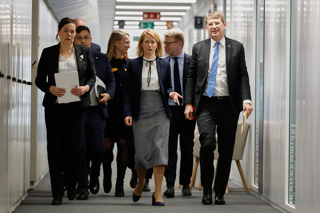 European Union foreign policy chief Kaja Kallas, center, walks with Minister for Foreign Affairs and Research of Greenland Vivian Motzfeldt, left, and Denmark's Defense Minister Troels Lund Poulsen, right, prior to a meeting at EU headquarters in Brussels, Monday, Jan. 19, 2026. (AP Photo/Geert Vanden Wijngaert)
