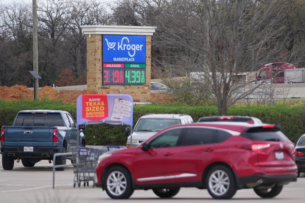 Gas prices are visible on a marquee outside of a Kroger grocery store Monday, March 9, 2026, in Arlington, Texas. (AP Photo/Julio Cortez)