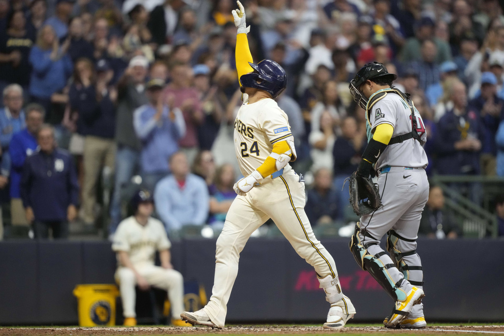 Milwaukee Brewers' William Contreras (24) reacts to hitting a home run during the third inning of a baseball game against the Arizona Diamondbacks Tuesday, Aug. 26, 2025, in Milwaukee. (AP Photo/Kayla Wolf)