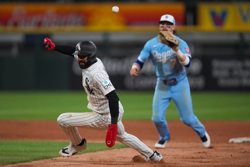 Chicago White Sox's Derek Hill, left, is caught in between bases and tagged out by Kansas City Royals shortstop Bobby Witt Jr. (7) during the eighth inning of a baseball game, Thursday, May 14, 2026, in Chicago. (AP Photo/Erin Hooley)