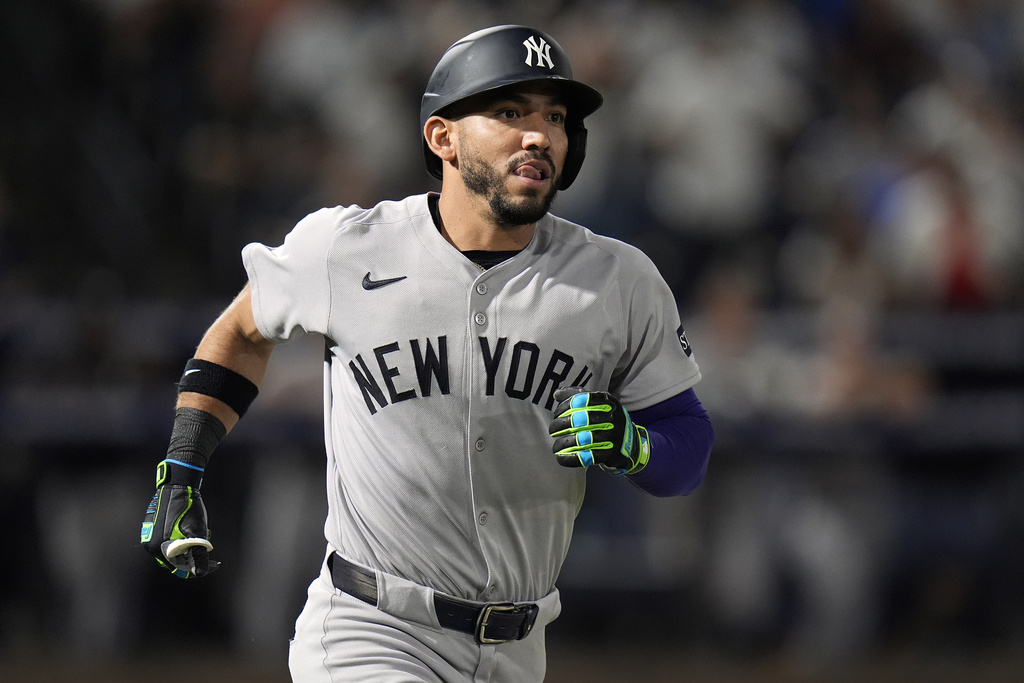 New York Yankees' José Caballero watches his two-run home run off Tampa Bay Rays pitcher Shane Baz during the second inning of a baseball game Tuesday, Aug. 19, 2025, in Tampa, Fla. (AP Photo/Chris O'Meara)