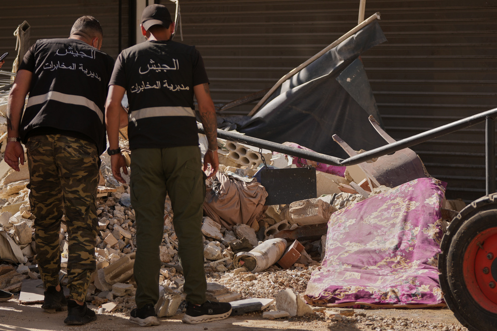 Lebanese intelligence officers look at an unexploded missile, centre, at the site where an Israeli airstrike hit a building in Dahiyeh, Beirut's southern suburb, Lebanon, Sunday, June 7, 2026. (AP Photo/Hassan Ammar)