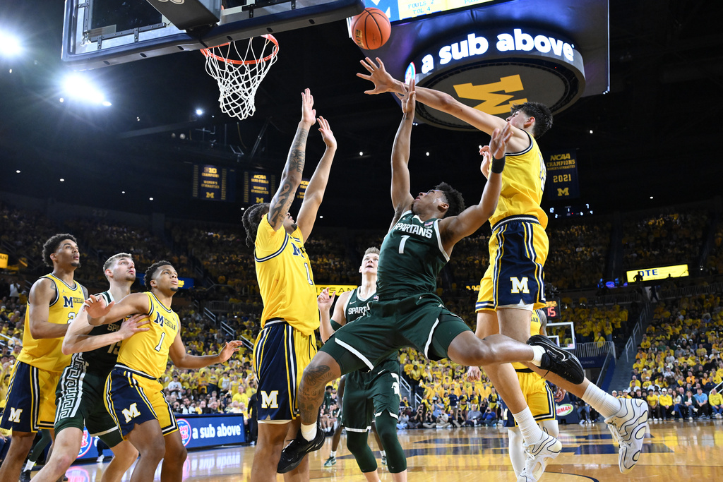Michigan St guard Jeremy Fears Jr. (1) puts up a shot between Michigan guard Roddy Gayle Jr, left, and Michigan center Aday Mara in the first half of an NCAA college basketball game in Ann Arbor, Mich., Sunday, March 8, 2026. (AP Photo/Lon Horwedel)
