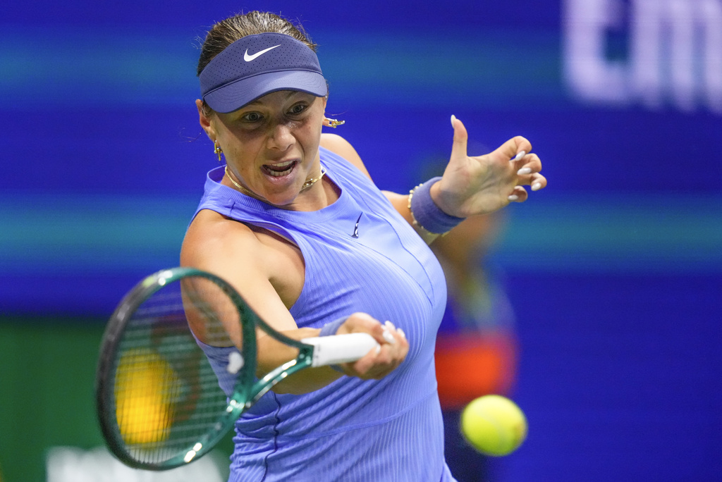 Amanda Anisimova, of the United States, returns a shot to Naomi Osaka, of Japan, during the women's singles semifinals of the U.S. Open tennis championships, Thursday, Sept. 4, 2025, in New York. (AP Photo/Yuki Iwamura)