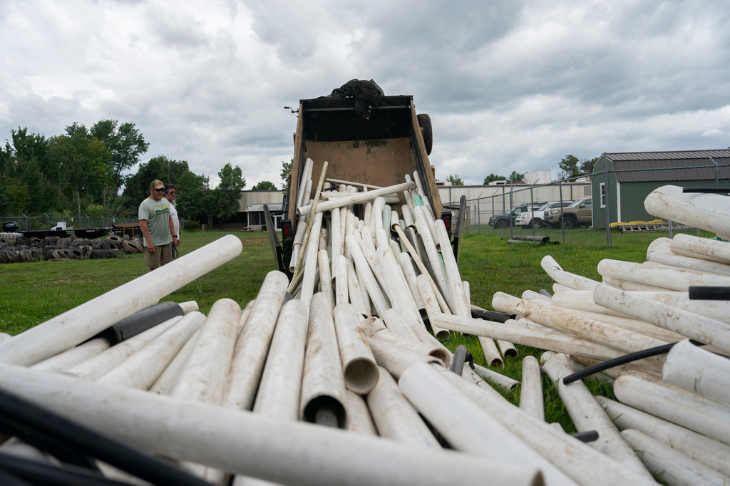 IPEX PVC pipe cleared from the riverbank is dumped at MountainTrue headquarters Wednesday, July 22, 2026, in Alexander, N.C. (AP Photo/Allison Joyce)