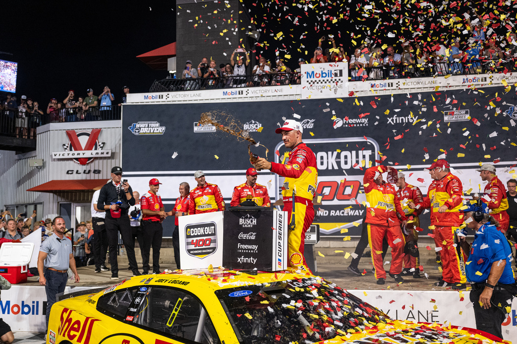 Team Penske driver Joey Logano (22) celebrates in victory lane after winning the Cook Out 400 at Richmond Raceway, Saturday, Aug. 15, 2026, in Richmond Va. (AP Photo/Robert Simmons)