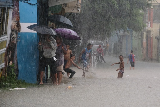Children play in a street flooded by rains caused by Tropical Storm Melissa in Santo Domingo, Dominican Republic, Friday, Oct. 24, 2025. (AP Photo/Ricardo Hernandez) Children play in a street flooded by rains caused by Tropical Storm Melissa in Santo Domingo, Dominican Republic, Friday, Oct. 24, 2025. (AP Photo/Ricardo Hernandez)