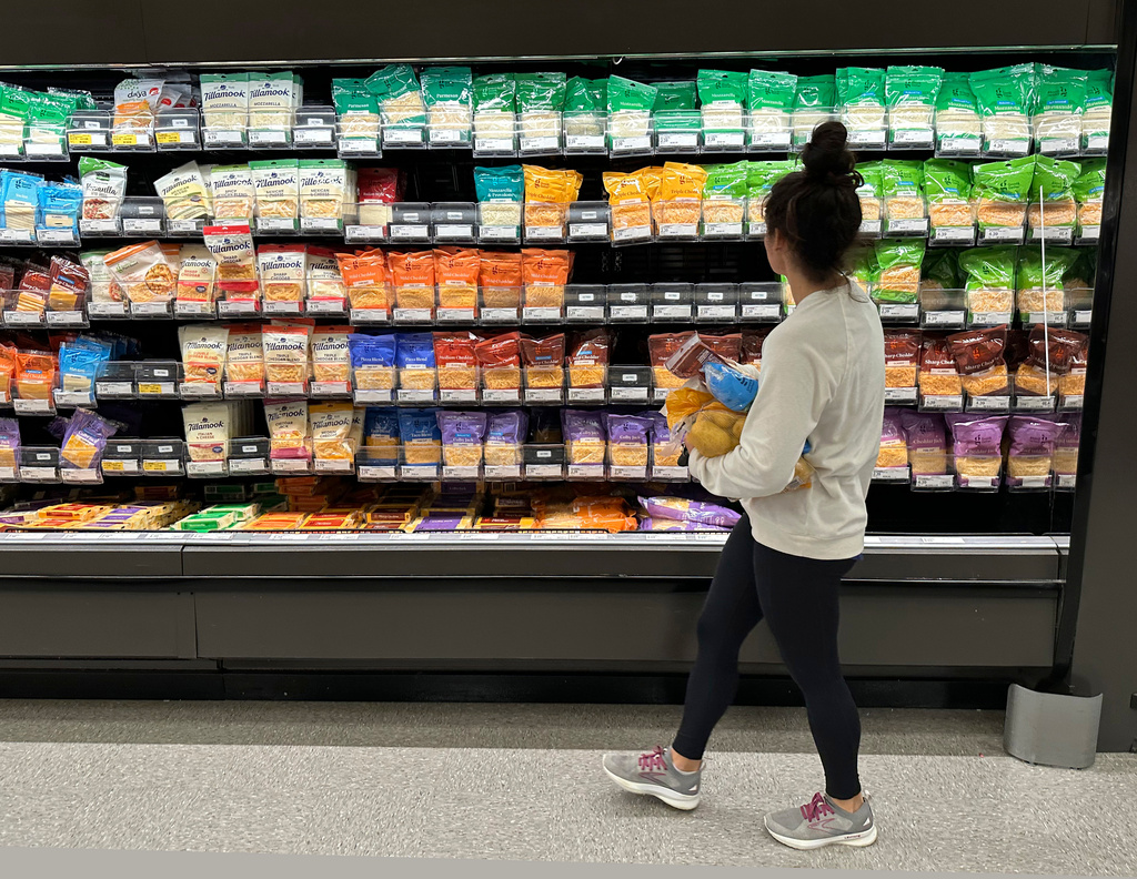 FILE - A shopper peruses cheese offerings at a Target store Wednesday, Oct. 4, 2023, in Sheridan, Colo. (AP Photo/David Zalubowski, File)