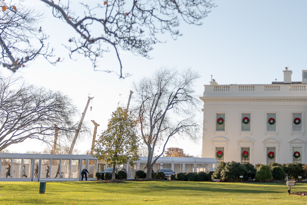 People exit through a newly constructed covered walkway on the North Lawn following a White House tour, Wednesday, Dec. 3, 2025, in Washington, as tours resume for the first time since construction of a new ballroom began at the White House. (AP Photo/Julia Demaree Nikhinson)