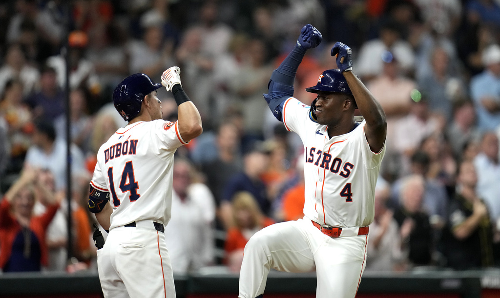 Houston Astros' Jesus Sanchez (4) celebrates with Mauricio Dubon (14) after his home run against New York Yankees relief pitcher Luke Weaver during the seventh inning of a baseball game Thursday, Sept. 4, 2025, in Houston. (AP Photo/Karen Warren)