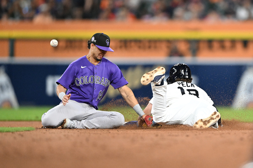 Detroit Tigers' John Peck, right, steals second base as Colorado Rockies shortstop Ezequiel Tovar can not handle the throw during the sixth inning of a baseball game, Friday, Sept. 11, 2026, in Detroit. (AP Photo/Jose Juarez)